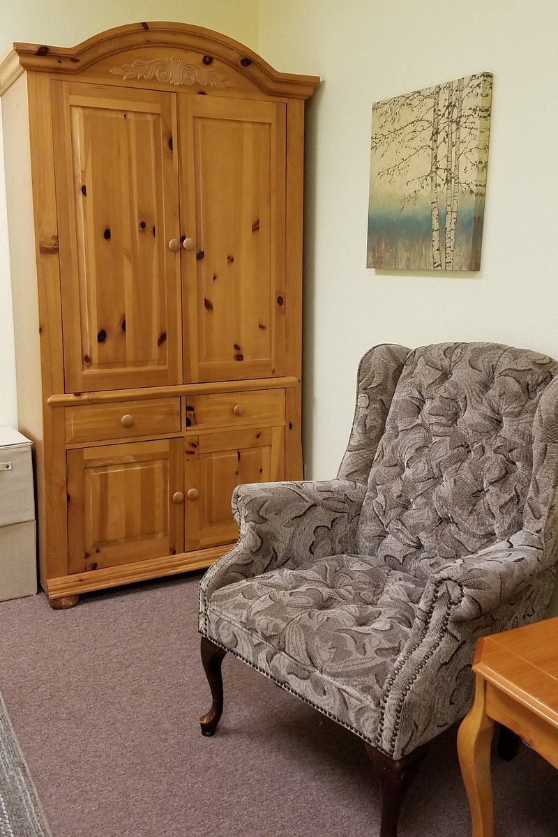 Chair and armoire in massage treatment room